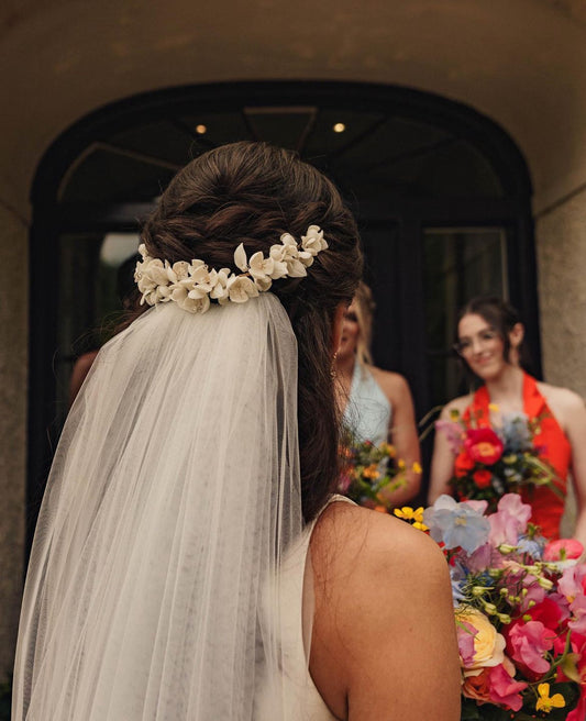 Bride wearing a hair vine over a veil handmade by petal and pearl accessories